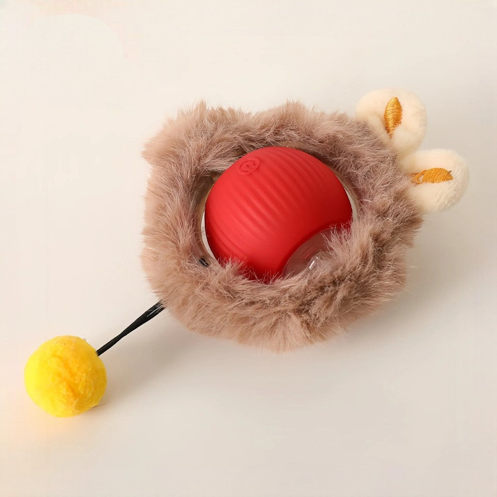 Balle électrique interactive Esprit Chat en caoutchouc rouge avec revêtement en peluche marron et pompon jaune.