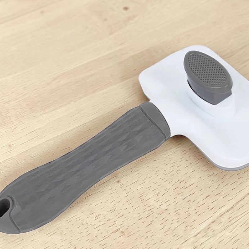 Brosse de toilettage Esprit Chat en plastique blanc et gris pour chat avec bouton poussoir