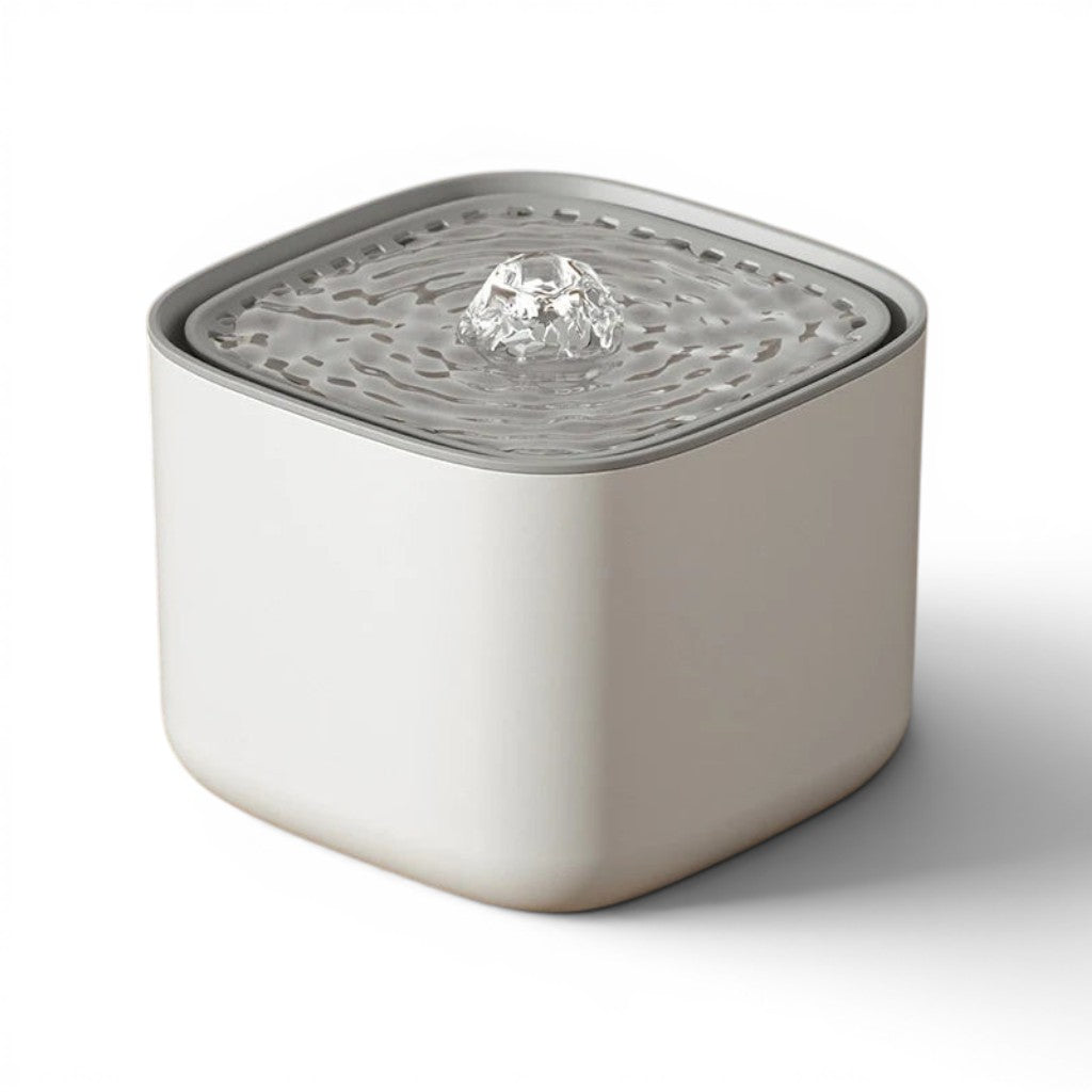 Fontaine à eau blanche en plastique pour chats, avec un jet d'eau central et un design moderne.
