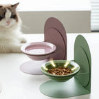Gamelle en céramique Esprit Chat avec support réglable pour chat, disponible en rose et vert sur une table