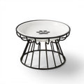 Gamelle Esprit Chat en céramique blanche avec motif patte, sur support en métal noir, design ergonomique pour chat.