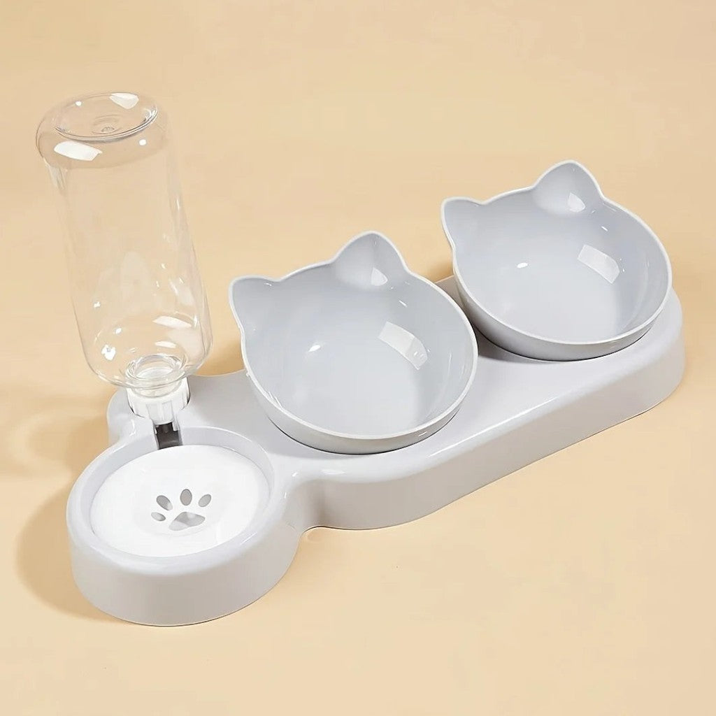 Gamelle ergonomique grise en plastique pour chat, avec distributeur d'eau intégré et design en forme de tête de chat.