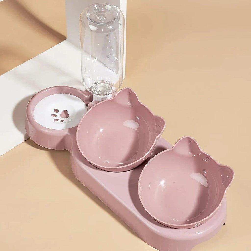 Gamelle ergonomique rose en plastique pour chat, avec distributeur d'eau intégré et design en forme de tête de chat.