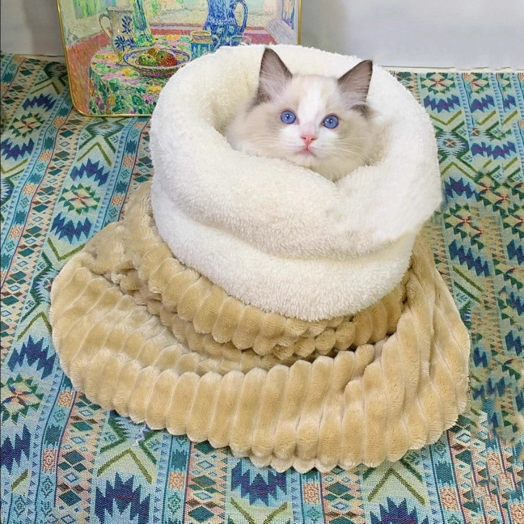 Chat Ragdoll aux yeux bleus blotti dans un sac de couchage en peluche Esprit Chat beige et blanc