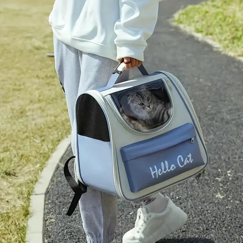 Sac à dos de transport Esprit Chat bleu et blanc avec fenêtre transparente pour chat, porté à la main en extérieur.